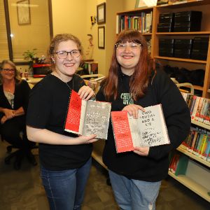  Students displaying autographed books.